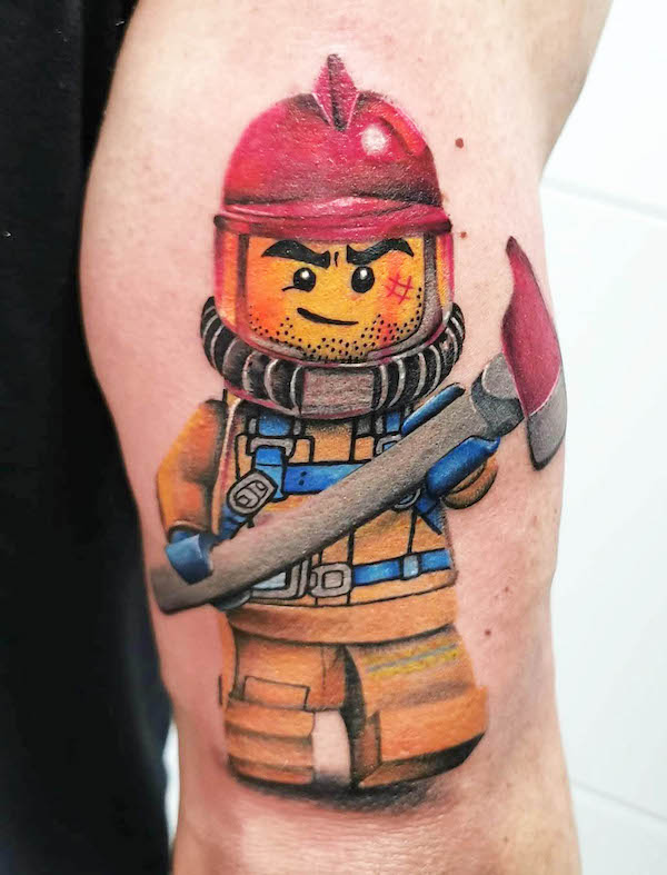 Lego firefighter tattoo by @black_cherry_tattoo