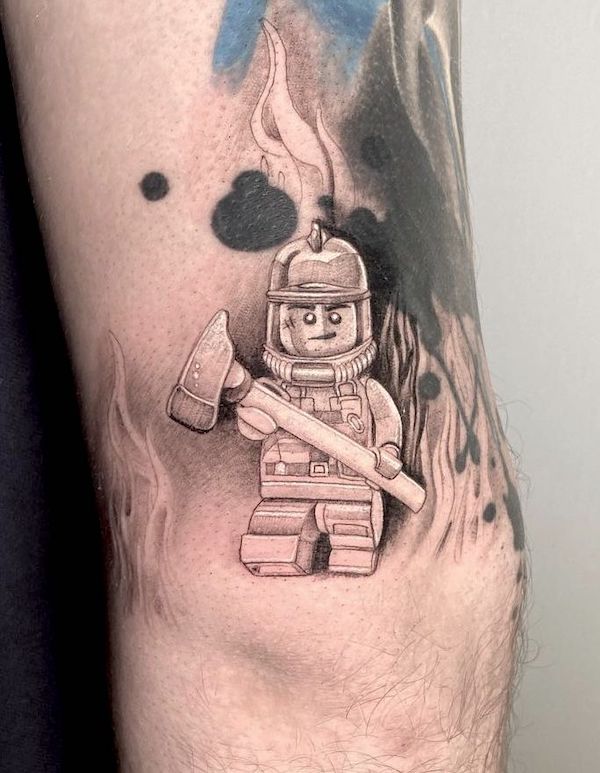 Black and grey lego fireman tattoo by @carolinpehr_tattoo