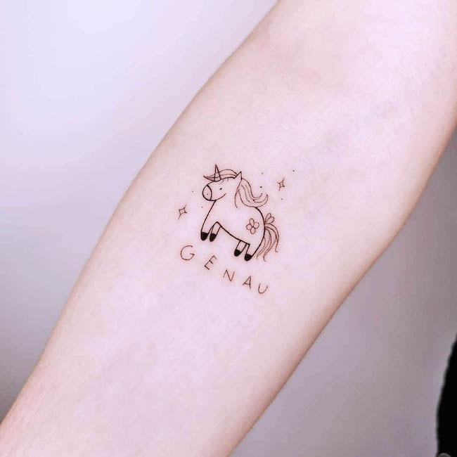 Un tatuaje femenino de unicornio brillante de @nicolka.ink.