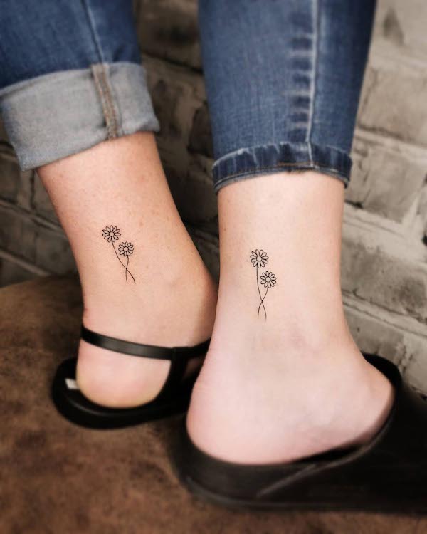 Floral mother daughter tattoos on the ankle by @emilia_paw_arts