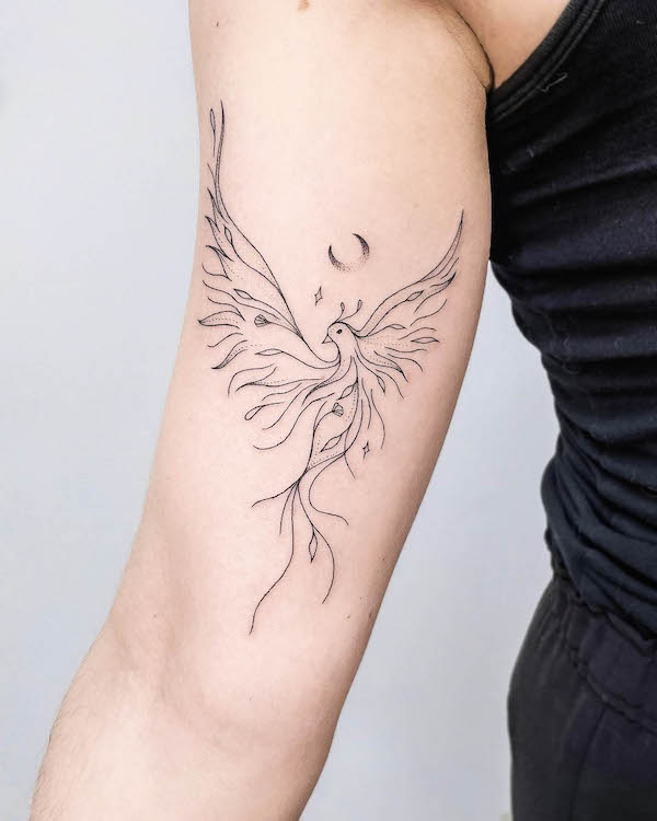 Sleek fine line phoenix arm tattoo by @nothingwildtattoo