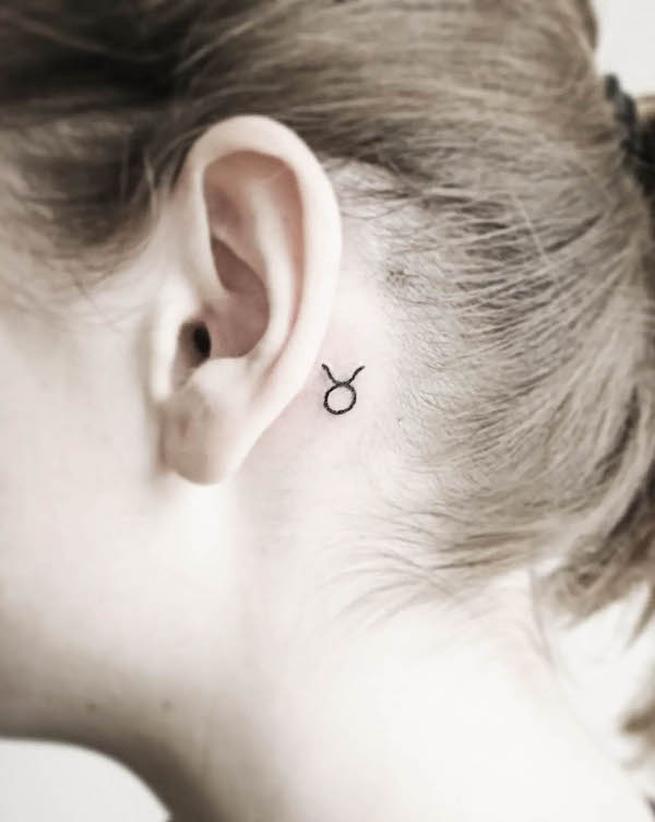 Tiny Taurus symbol behind the ear by @rusalka.ink_
