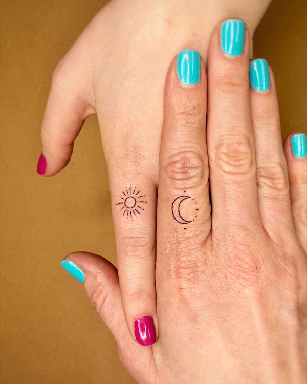 Matching sun and moon finger tattoos for mother and daughter by @trikona.tattoos