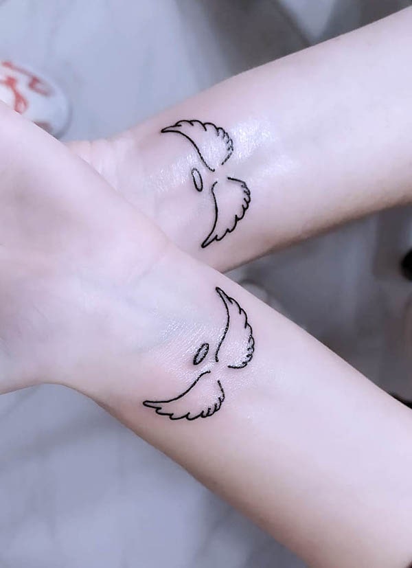 Matching angel wing tattoos by @edge_tattoo_studio