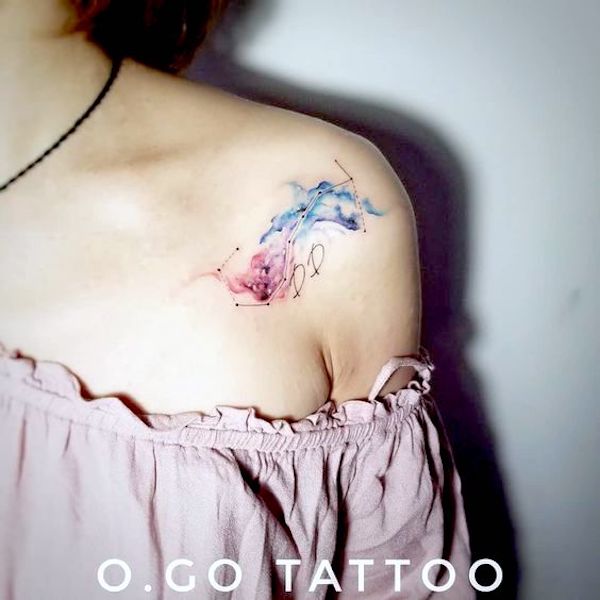A watercolor Scorpio shoulder tattoo by @O.Go_.Tattoo
