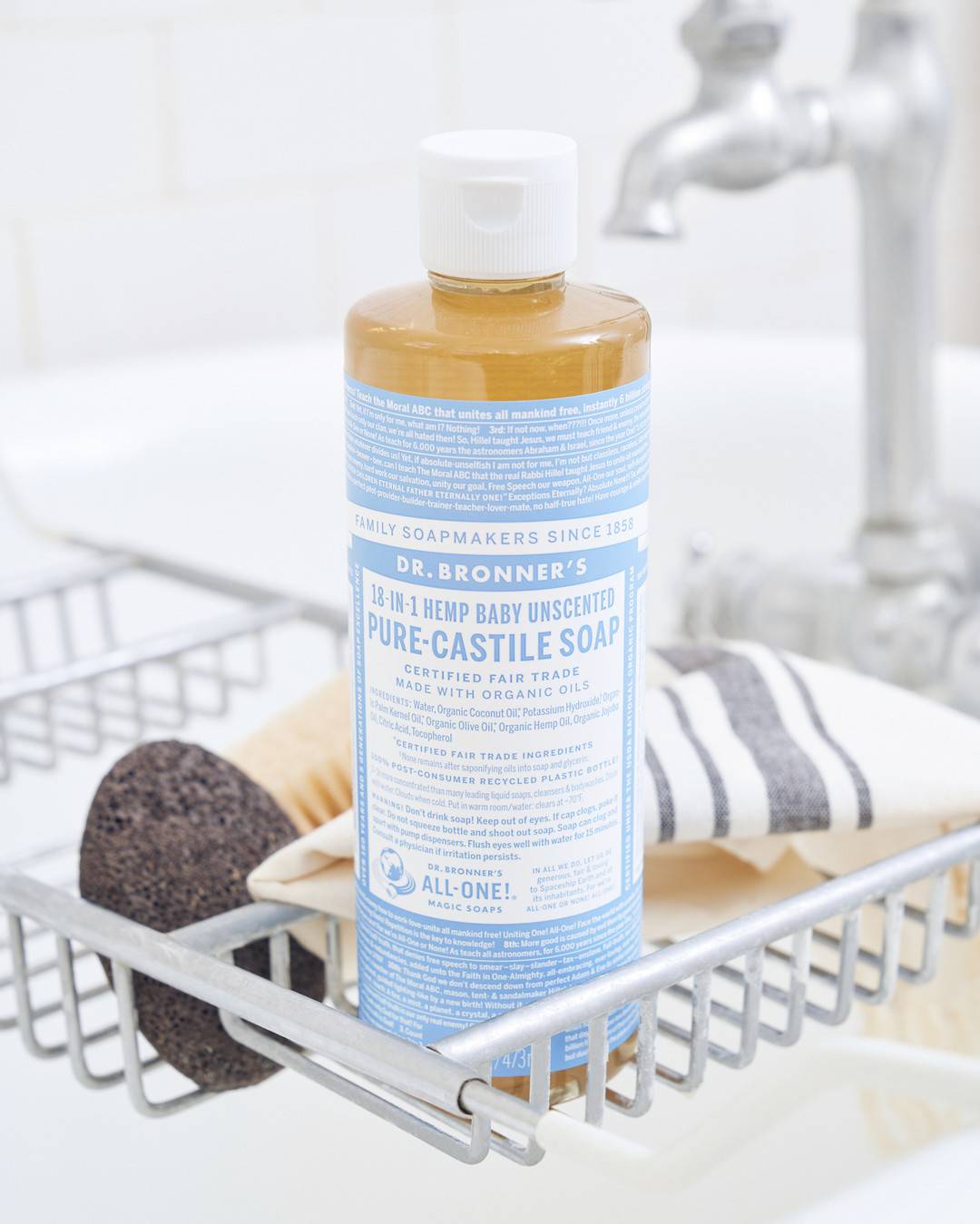 a bottle of dr bronner's pure castile soap on a soap tray