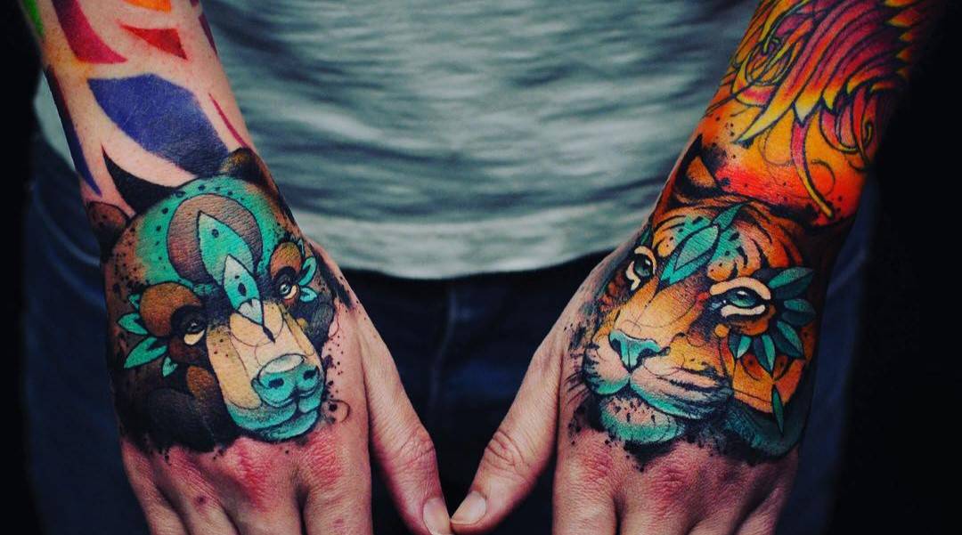 a bear and a tiger tattoo on arms